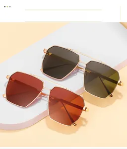 Close-up of double bridge polygon sunglasses with orange and tea grey lenses and gold frame