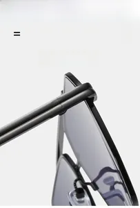 Detailed close-up of double-bridge sunglasses showing flexible hinges and black frame