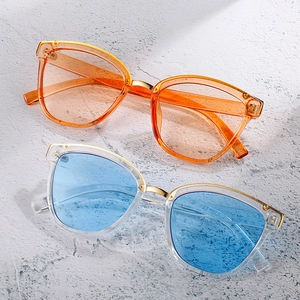 Retro oversized sunglasses with transparent orange and blue frames and gold metal bridge