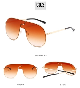 Détail de lunettes de soleil sans monture avec verres dégradés orange et cadre doré