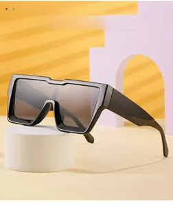 Detail of stylish oversized square black frame sunglasses on a modern geometric pedestal
