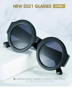 Detail view of large round two-tone sunglasses on white geometric display stand