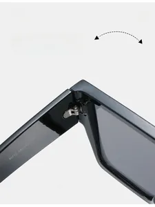 Detail of silver metal hinge and internal model specs on black square sunglasses