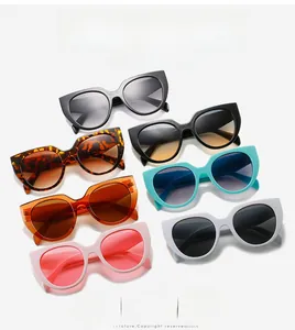 Flat lay of cat-eye sunglasses in multiple colors including black, leopard, and pink