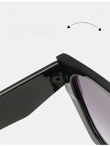 Close-up of durable metal hinge on black geometric sunglasses with gradient lenses