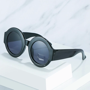Vintage oversized round black sunglasses with polished frames and dark gray lenses