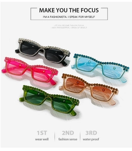 Flat lay of colorful Y2K rectangular sunglasses with sparkling rhinestone embellishments