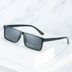 Retro rectangular sunglasses with black frame and dark grey lenses on white display stand