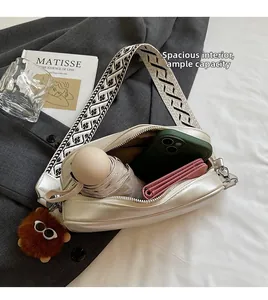 Detailed view of white crossbody bag interior showing spacious storage for daily items