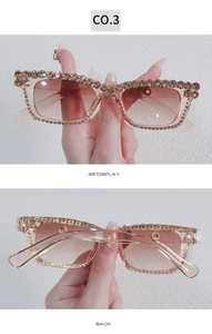 Detail of square oversized sunglasses featuring champagne frames with crystal encrusting
