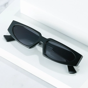Fashionable black triangular cat eye sunglasses for women with thick frames and dark lenses