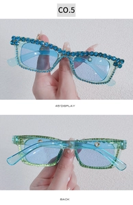 Detailed macro view of square Y2K sunglasses with blue gradient frame and rhinestones