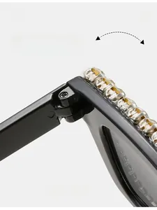 Detail of square frame sunglasses showing durable metal hinges and rhinestone embellishments