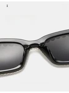 Detail of square sunglasses featuring rhinestone-encrusted edges and comfortable nose pads