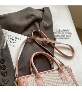 Detailed view of pink leather trim and woven panels with adjustable shoulder strap