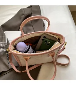 Interior view of woven tote bag showing spacious capacity for phone and umbrella