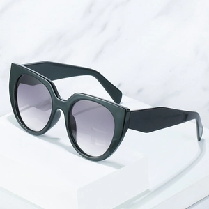 Modern oversized cat-eye sunglasses with thick dark green frames and gradient lenses