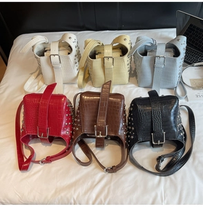 Multi-color crocodile pattern bucket bags with silver rivets in a lifestyle setting