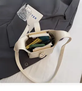 Interior view of off-white crocodile pattern bag showing daily essentials and room