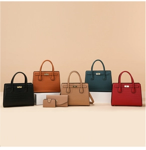 Detail of stone textured handbag set with gold buckles in five different colors