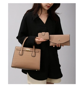 Detailed view of camel faux leather 3-piece bag set with stone pattern and metal hardware