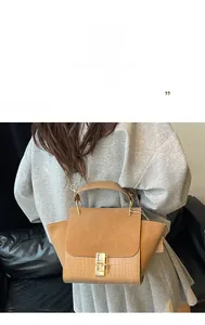 Detail of camel crossbody bag with frosted suede and crocodile pattern leather texture