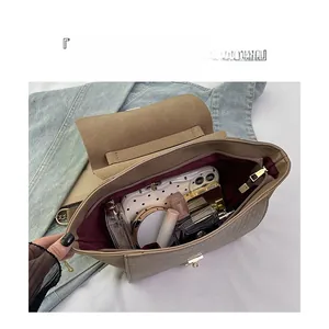 Internal view of khaki wing bag with burgundy lining showing large storage capacity