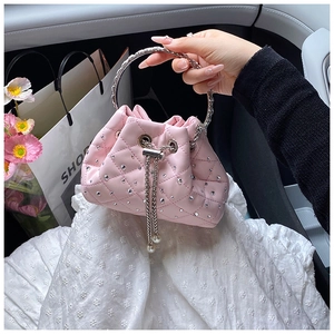 Detail of pink rhinestone bucket bag with silver metal ring handle and pearl drawstring