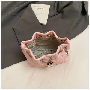 Top view of pink quilted bucket bag with rhinestones, pearl closure and fabric lining