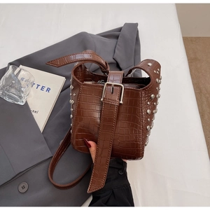 Brown crocodile pattern bucket bag with silver studs and adjustable shoulder strap