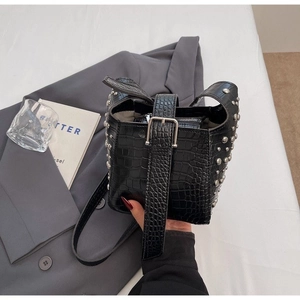 Trendy black crocodile pattern bucket bag with silver rivet studs and punk style
