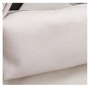 Close-up of white lychee pattern leather texture and premium stitching on the cloud bag