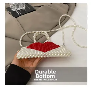 Detail showing durable base of handmade beaded mini handbag with red heart pattern