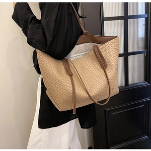 Detail of khaki woven tote bag showing spacious grey interior and internal zipper pocket