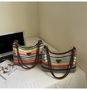 Detail of colorful striped woven shoulder bags with pearl charms and leather handles