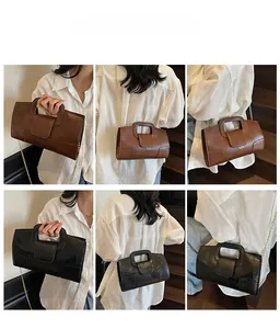 French style handbag in black and caramel colors with gold chain straps shown from multiple angles