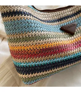 Detail of colorful striped straw bag featuring high-quality woven texture and fashion label