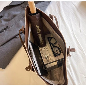 Top view of spacious woven tote bag showing internal storage for tablets and umbrellas