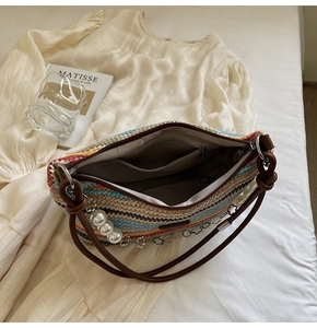 Top view of woven tote bag showing brown lining, internal zipper pocket and stripe texture