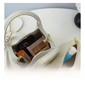 Detailed interior view of white crocodile pattern tote bag with matching zipper pouch