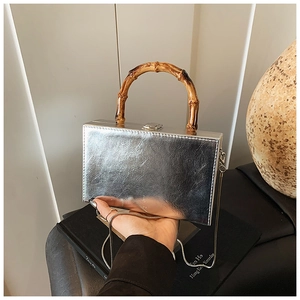 Silver mirror mini box bag featuring a distinctive charcoal bamboo top handle and chain strap