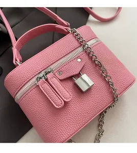 Detail of pink lychee textured box bag featuring silver hardware and chain strap