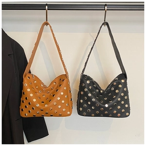 Detail view of rivet studded hobo bags in black and brown textured leather finish