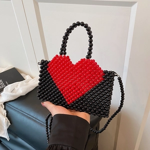 Handmade black beaded handbag with red heart pattern and dual strap for crossbody wear