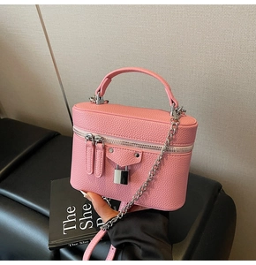 Pink lychee grain leather crossbody bag with silver lock and metal chain strap