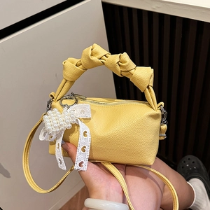 Bright yellow lychee leather mini dumpling bag with knotted handle and pearl lace pendant