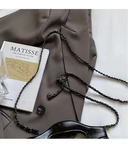 Detail view of the smooth leather bag with polished black nickel woven chain strap