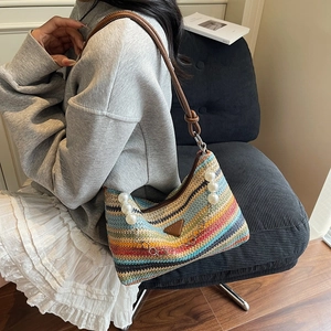 Striped woven shoulder bag with pearl accents and leather strap for summer beach vacation