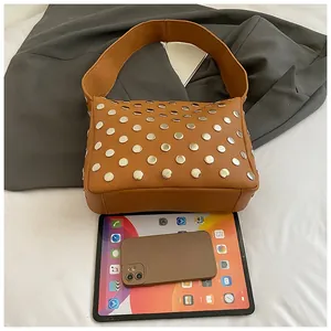 Detailed view of brown lychee texture leather shoulder bag with silver rivet studs decoration