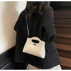 Quilted crossbody bag in ivory white featuring a metal twist lock and silver chain strap